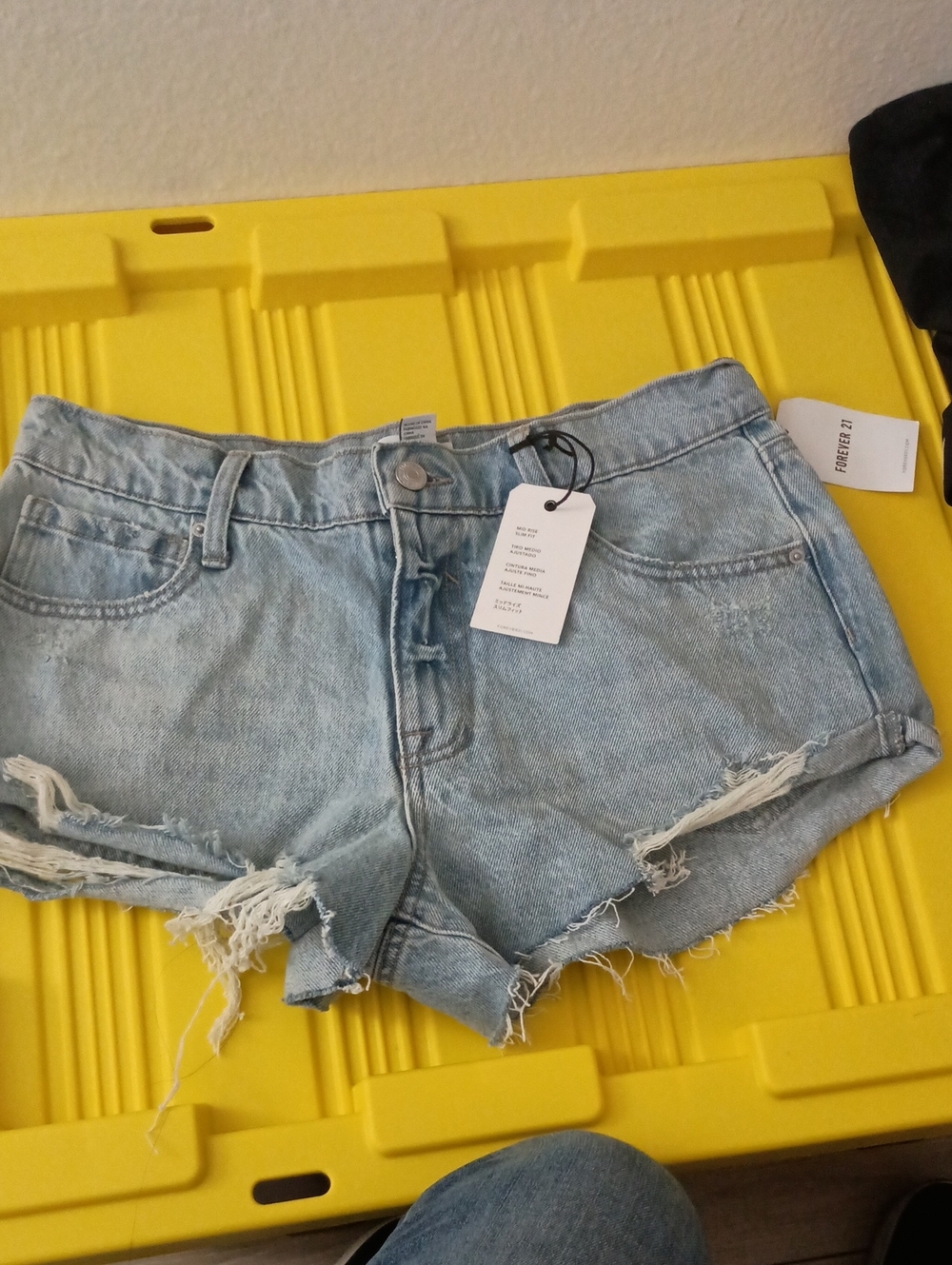 Forever 21 denim shorts feature distressed detailing and a frayed raw hem